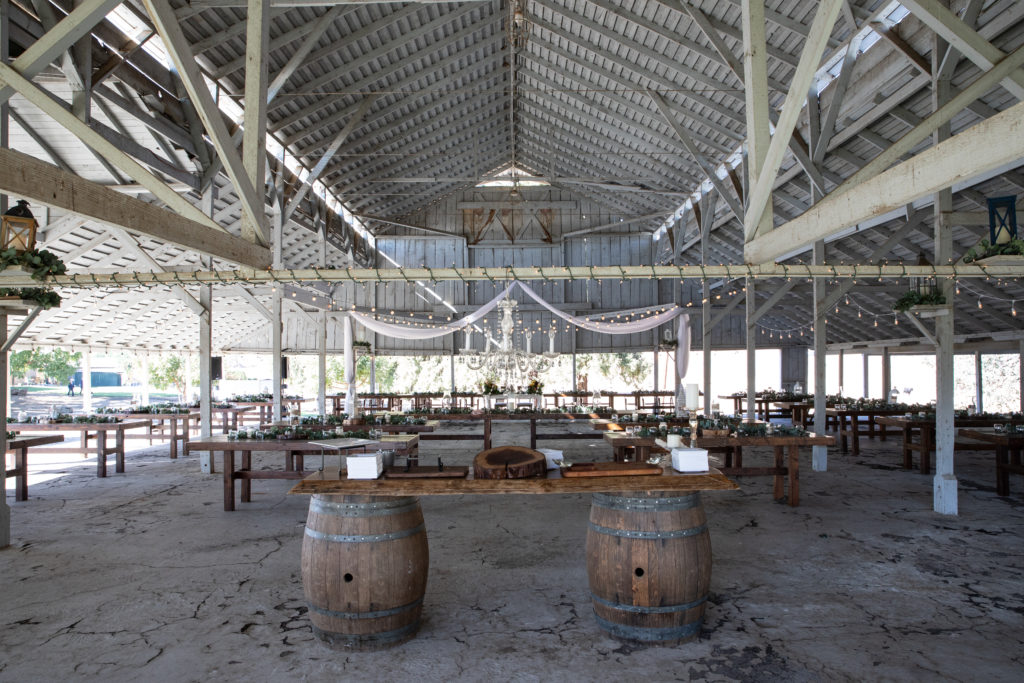 wedding reception barn with wine barrels