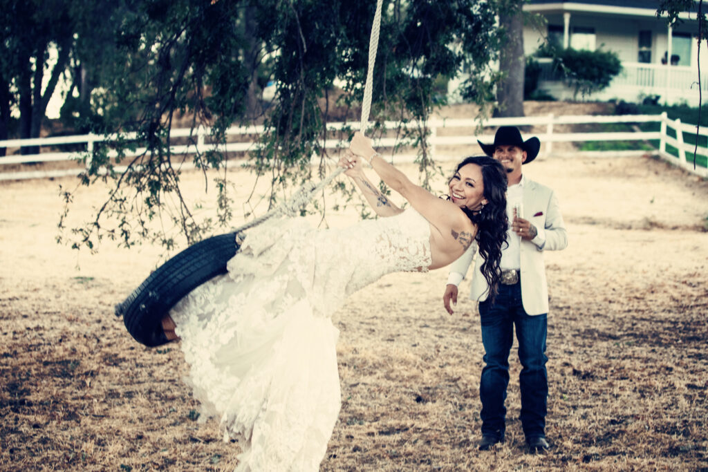 Bride and groom on tire swing